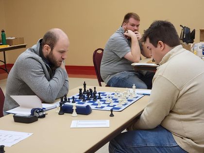 People playing chess at a monroe chess tournament